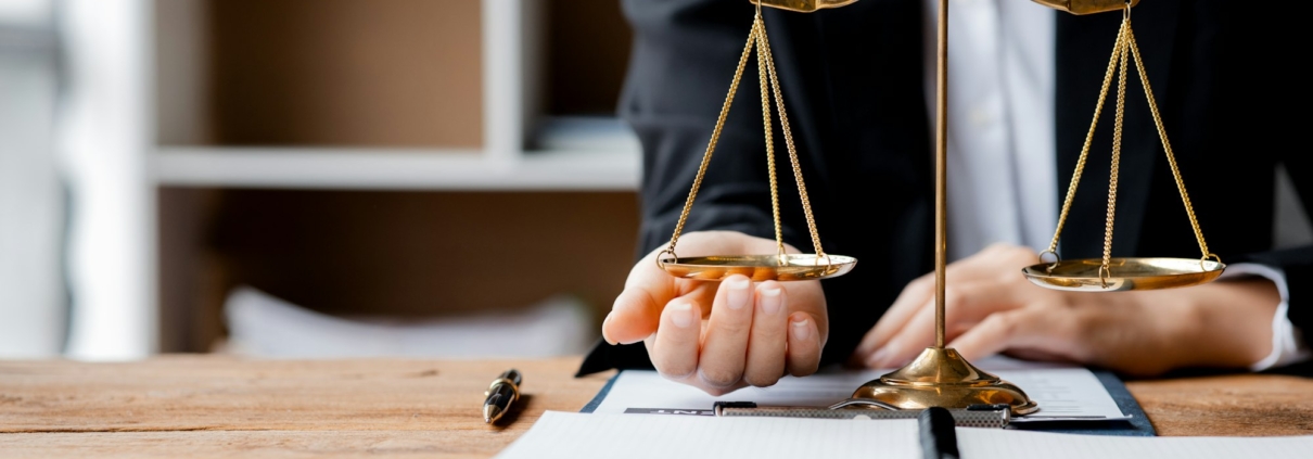 Construction Adjudication Intricacies An individual exercises his hand under the scales of justice.